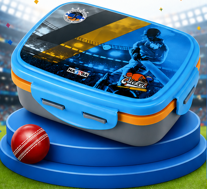 A blue and gray lunch box with orange accents, featuring a cricket-themed printed lid design with a player, stadium scene, and 'MADE IN INDIA' and 'Cricket' logos. The box is displayed on blue tiered steps with a red cricket ball in the foreground, against a blurred sports-stadium background.